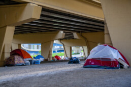 Tents under a highway overpass