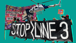 Activists in the foreground with a helicopter hovering behind them