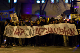 Protestors hold a banner reading No War on Afghanistan