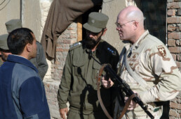 A US military official talks with an Afghan civilian