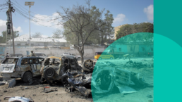 Mangled cars in the foreground show the effects of a drone strike