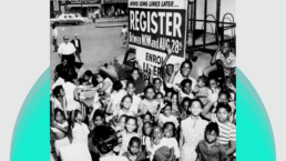 A large group of African-American children stand in front of a voter registration sign