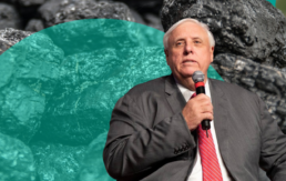 Jim Justice sits in front of a stack of coal