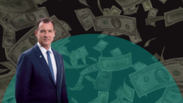 Rep. Tom Suozzi stands in front of a background of falling money