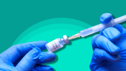 gloved doctors hands preparing COVID vaccine