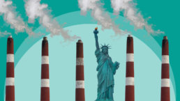 The Statue of Liberty stands among smokestacks billowing smoke