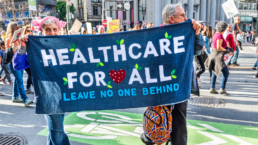 california medicare for all activists marching with healthcare for all banner