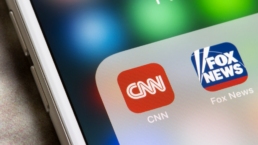 corporate media apps on phone screen, cnn and fox news
