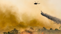 wildfire and helicopter dropping water