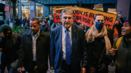 Senator Joe Manchin is confronted by climate activists as he leaves hi yacht on his way to capitol hill
