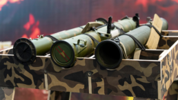 Anti-tank RPGs painted in military camo colors and laid in a rack for sale