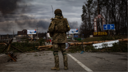 Ukrainian soldier stands on the check point to the city Irpin near Kyiv during the evacuation of local people under the shelling of the Russian troops