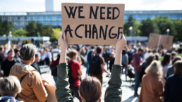 climate change protest sign that says we need a change
