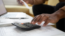 hand using calculator to calculate finances