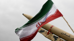 Iranian flag with a missile in the background