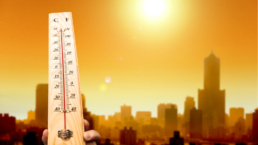 record heat thermometer and city bathed in warm sun light
