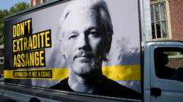 A mobile billboard featuring WikiLeaks founder Julian Assange on it is parked at Lincoln Inn Fields in London