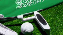 A putter, a golf ball, and the Saudi Arabian flag