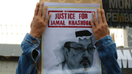 protestor with sign that says Justice for Jamal Khashoggi