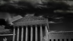 The US Supreme Court in Washington DC with dark storm clouds