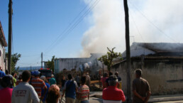 A fire burns in Matanzas, Cuba, with onlookers in the foreground