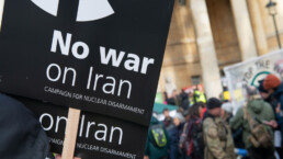 Anti war protester with placard at the NO WAR WITH IRAN demonstration