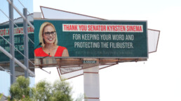 Bought by Election Transparency Initiative, a highway billboard sign thanks Senator Kyrsten Sinema for 
