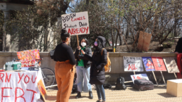 protestor with sign demanding biden cancel student debt