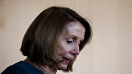 Pelosi looks down at the ground