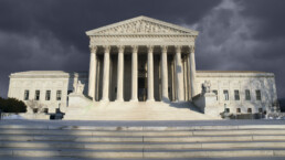 Supreme Court with storm clouds gathering behind it
