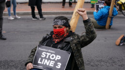 A defiant Line 3 protester raises her fist in an effort to shut down the Line 3 oil pipeline.