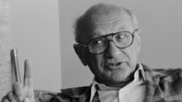 Milton Friedman holds one finger up