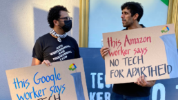 Tech workers hold signs outside a protest