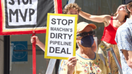 stop manchins dirty pipeline deal, sign held by protester