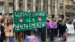 The Extinction Rebellion protesting climate change while occupying Bank, London with a sign reading 