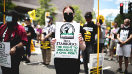 Starbucks protestors hold pro-union signs