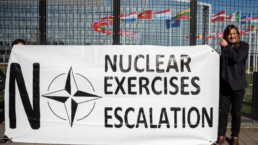 Activists hold a banner protesting nuclear exercises outside NATO headquarters