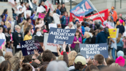 People hold signs at an abortion rights rally