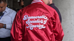 A DSA member wears a red DSA jacket