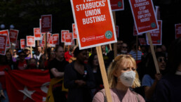 Activists march at the Starbucks Worker Solidarity Rally in support of unionization for baristas and other retail workers.