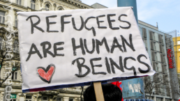 Refugees are human beings sign at a rally