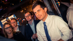 Pete Buttigieg standing in front of his husband looking upward. Wearing a white button down shirt with a thin blue tie. Presidential Candidate for 2020 May 15 2019 Los Angeles grassroots fundraiser