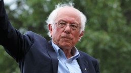 Bernie Sanders waves at a crowd in Des Moines