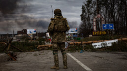 Ukrainian soldier stands on the check point to the city Irpin near Kyiv during the evacuation of local people under the shelling of the Russian troops.
