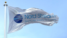 Flag with the Nord Stream logo waving to the fan on a clear day. Nord Stream is a gas pipeline that directly transports Russian gas to Western Europe.
