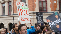 listen to science IPCC report sign at climate rally