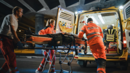 paramedics rush patient into ambulance EMT EMS