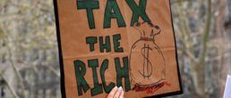 tax the rich sign at protest