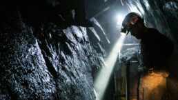 a miner stands in a coal mine
