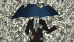 a man with an umbrella and dollar bills raining around him